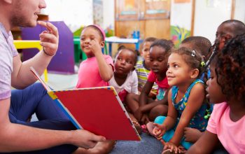 Volunteer Teacher Reading to a Class of Preschool Kids